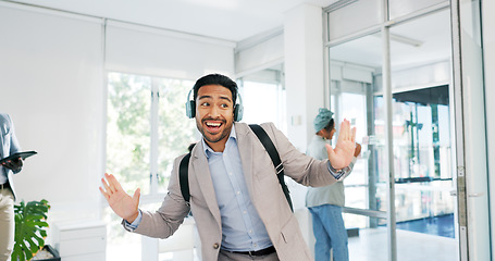 Image showing Music, dance and motivation with a business man walking in an office while feeling positive or carefree. Success, happy or smile with a happy male employee arriving at work in headphones with a smile