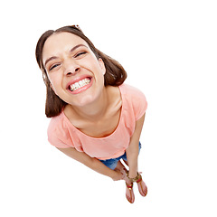 Image showing Woman, studio portrait and above with funny face, smile and comic with fashion by white background. Model, young and happy with trendy clothes, top view and isolated with happiness, crazy and joke