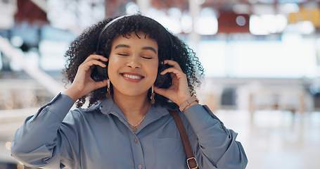 Image showing Music, headphones and black woman in mall for freedom, relax and calm energy, dance, listening and happy with her travel journey. Urban building, gen z and audio technology for inspiration in retail