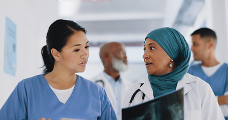 Image showing Doctors, x ray and women walking in hospital, clinic and healthcare planning, consulting and teamwork. Diversity, medical workers and xray anatomy analysis for heart risk, asthma lungs and body chart