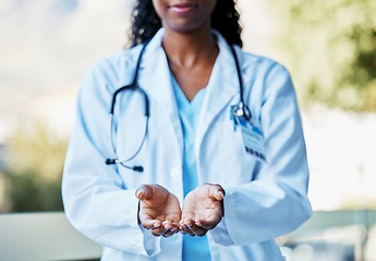 Image showing Healthcare, open hands and woman doctor working in a hospital for volunteer, support or charity. Help, stethoscope and African female medical worker with a giving hand gesture in a medicare clinic.