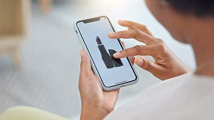 Image showing Shopping online and scrolling through makeup products to find a sale or discount. Hands of a woman browsing cosmetics on her phone from above. Enjoying the convenience and ease of purchasing apps