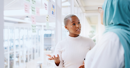 Image showing Teamwork, business people and leadership of black woman with sticky note in office workplace. Coaching, collaboration and female employees brainstorming sales or marketing strategy on glass wall.