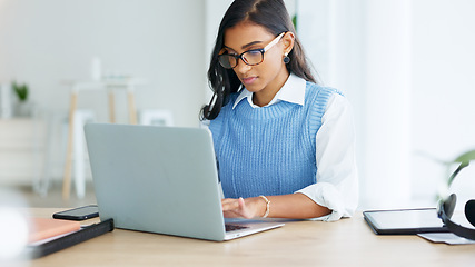 Image showing Young woman happily doing business and networking by email on laptop. Professional female is stylish and creative while being alone in office. She is using technology to advance her career