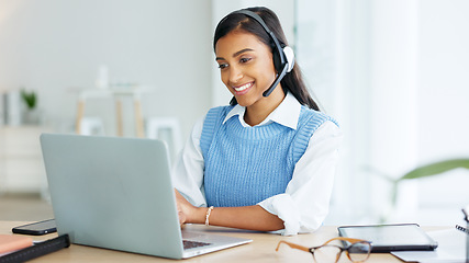 Image showing Call center agent talking to clients while wearing a headset and answering their questions while typing on a laptop online. Helpline worker giving advice to people and helping them with problems