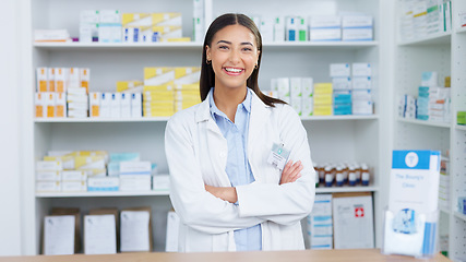 Image showing Portrait of a cheerful and friendly pharmacist using a digital tablet to check inventory or online orders in a chemist. Young latino woman using pharma app to do research on medication in a pharmacy