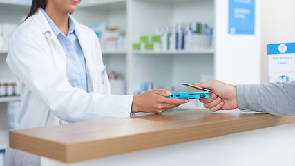 Image showing Patient buying medicine from pharmacist at the pharmacy store. Customer receives prescription medication at the chemist store from medical doctor. Healthcare professional accepts credit card payment