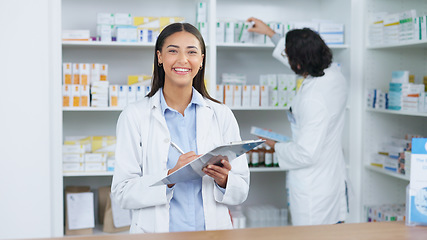 Image showing Portrait of a cheerful and friendly pharmacist using a digital tablet to check inventory or online orders in a chemist. Young latino woman using pharma app to do research on medication in a pharmacy