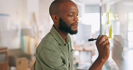 Image showing Sticky notes, meeting and businessman writing idea, vision and brainstorming in office. Black man with post it notes on glass wall for presentation in business meeting, thinking and working on ideas