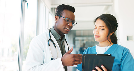 Image showing Healthcare team, discussion and tablet with a doctor and nurse talking about medicine research. Black man and woman hospital staff meeting using technology for planning, communication and innovation