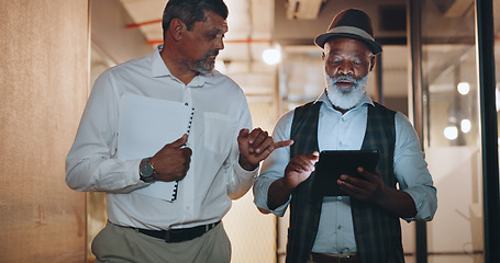 Image showing Partnership, tablet and businessmen walking in the office analyzing, talking and planning a project. Technology, professional and senior male employees working on a mobile device in the workplace.