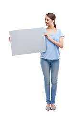 Image showing Woman, blank board and happy standing in white background for advertising, marketing and branding vision. Model, smile and holding empty poster, billboard or news banner mockup isolated in studio