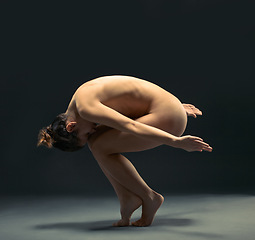 Image showing Body, nude and ballet with a model woman in studio on a dark background for dance or performance arts. Creative, skin and beauty with a female ballerina posing nude on black for artistic freedom