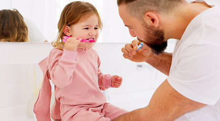 Image showing Father and child brushing their teeth with toothbrush together in bathroom of their home. Happy, dental care and man teaching his girl kid oral hygiene routine with toothpaste for health and wellness