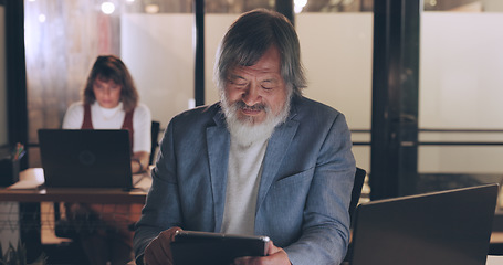 Image showing Senior businessman, tablet and night in office for planning, schedule or strategy for digital marketing. Man, woman and late in modern office with laptop, reading or typing for email, success or goal