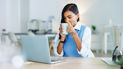 Image showing Young business woman taking a coffee break after a completed task or meeting a deadline while working on a laptop at work. Pleased female corporate professional resting after sending sending an email