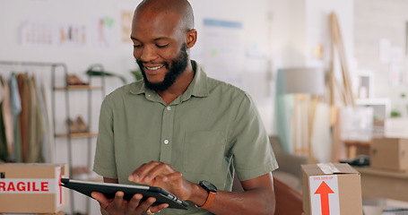 Image showing Tablet, creative and online order with a black man designer working in a workshop for shipping or delivery. Computer, ecommerce and logistics with a male managing stock or the shipment of goods