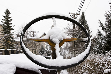 Image showing vintage streering wheel covered in snow