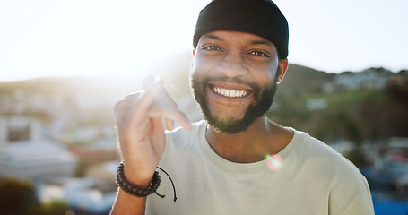 Image showing Black man, portrait and call me hand in city outdoors on holiday, vacation or trip. Face, smile and male from South Africa with calling hands gesture, comic and smiling, laughing and happy with life.