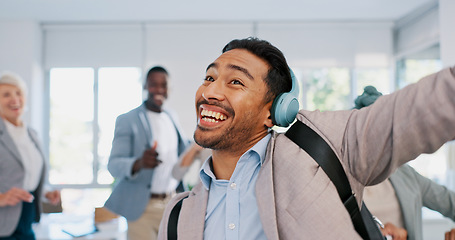 Image showing Music, dance and motivation with a business man walking in an office while feeling positive or carefree. Success, happy or smile with a happy male employee arriving at work in headphones with a smile