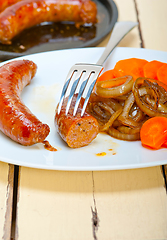 Image showing beef sausages cooked on iron skillet