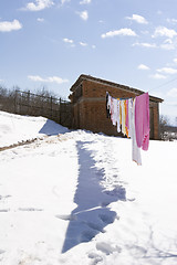 Image showing clothes hanging to dry in the snow