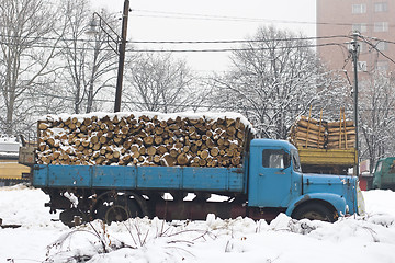 Image showing old truck with firewood in the snow