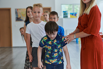 Image showing Preschool children wait in line for new and interesting games. Selective focus