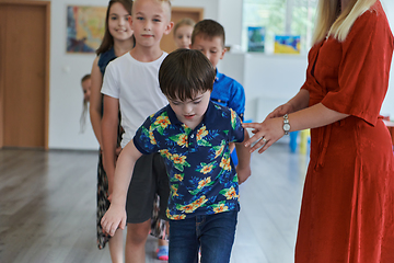 Image showing Preschool children wait in line for new and interesting games. Selective focus