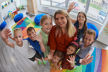 Image showing Children in a preschool institution standing in the classroom together with the teacher