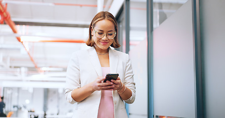 Image showing Business woman in office walking with smartphone for Seoul, global or international networking, communication and marketing. Happy asian employee using phone or cellphone in a corporate workspace