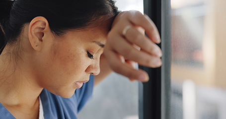 Image showing Doctor woman, burnout and anxiety in hospital, workplace and tired in healthcare job, stress or headache. Nurse, sad and exhausted in medical service, clinic or depression in health career by window