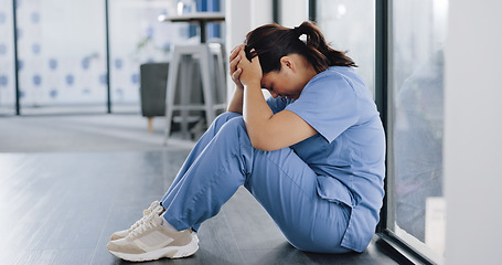 Image showing Healthcare, stress and sad nurse on floor with burnout, anxiety and headache working in emergency services. Medical care, mental health and health care worker with depression in hospital or clinic