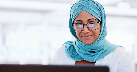 Image showing Muslim business woman, face and working at laptop, email and communication with focus and technology. Worker in hijab, corporate goals with internet, networking and research online for project