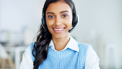 Image showing Portrait of a call center agent using a headset while consulting for customer service and sales support. Confident young businesswoman smiling while operating a helpdesk and looking confident