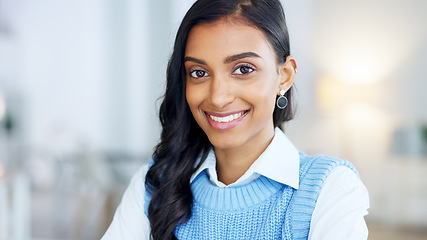 Image showing Confident and happy indian business woman feeling ambitious and motivated for success in a creative startup agency. Portrait of a young designer smiling while working on a laptop in a modern office.
