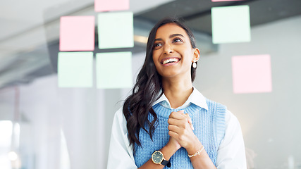 Image showing Focused young business woman thinking while brainstorming solutions for a project and marketing strategy in a creative startup agency. Designer planning ideas and information on a window in an office