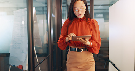 Image showing Business, technology and Asian woman in office, working with team on laptop, tablet and computer in workplace. Success, teamwork and female worker walking, meeting and planning for digital marketing