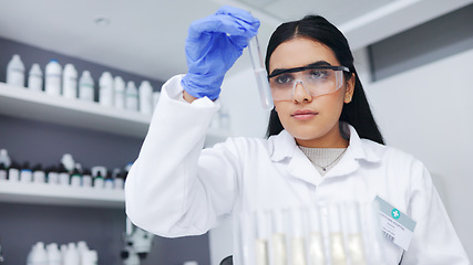 Image showing Young female scientists doing tube testing in a modern laboratory. Micro biologist examine liquid bacteria in glassware mixture to invent a vaccine cure for virus at innovative research hospital