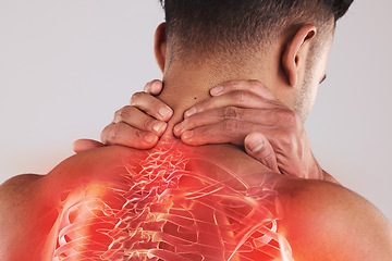 Image showing Man with a spinal injury, pain or accident with backache holding his neck in the studio. Scoliosis, sprain muscle and male with a spine or body medical emergency problem by a gray background.
