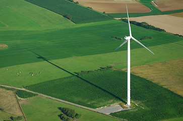 Image showing aerial view of windturbine and shadow