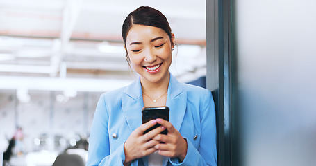 Image showing Business woman, phone and typing in office on social media, internet browsing or texting. Tech, mobile and happy female from Japan on break with smartphone for messaging, web scrolling or networking.