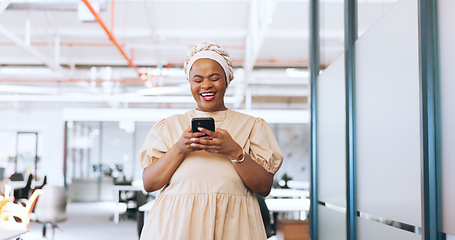 Image showing Black woman, phone and communication with a business contact while walking in a creative office laughing about funny meme notification. Happy african employee using mobile data on social network