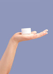 Image showing Hands, skincare and cream container in studio isolated on a purple background for hydration. Cosmetics, dermatology and woman or female model with lotion, creme or moisturizer for beauty aesthetics.