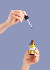 Image showing Skincare serum, model hands and essential oil product bottle for dermatology and cosmetics. Studio beauty, wellness and self care with hyaluronic acid for collagen production with purple background