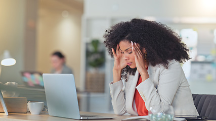 Image showing Stressed software analyst typing on laptop with headache and making a mistake while analysing business or company data. Worried professional rubbing forehead with hands while struggling and pressured