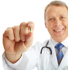 Image showing Portrait, doctor and man with pills in studio isolated on a white background. Face, healthcare and happy medical worker, pharmacist and mature male holding drug medicine, medication or capsule remedy