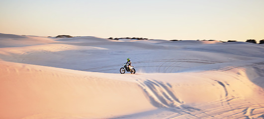 Image showing Desert, motorbike and extreme sports of a man on sand dunes in Africa doing sport fitness. Driving challenge, beach adventure and cycling travel of a athlete in nature training for moto cross