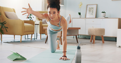 Image showing Yoga, tablet and woman with online video for stretching exercise in the living room of her house. Girl with balance during fitness workout on the internet with tech in the lounge of her home