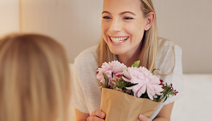 Image showing Flowers, gift and happy with mother and girl for mothers day, birthday or congratulations in family home. Gratitude, smile and love with child giving bouquet to mom for present and celebration